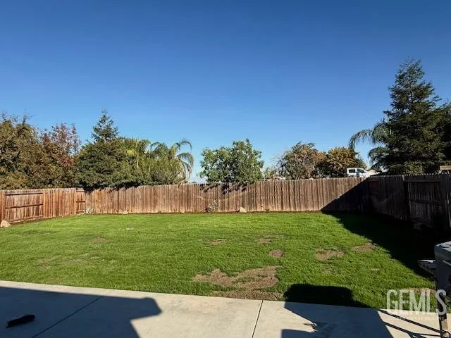a view of yard with swimming pool and green space
