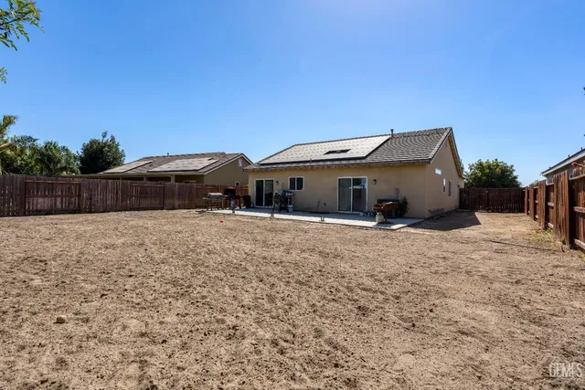 a front view of house with a garden