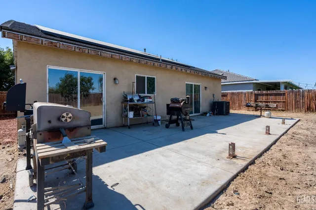 a living room with furniture a dining table and chairs with wooden floor