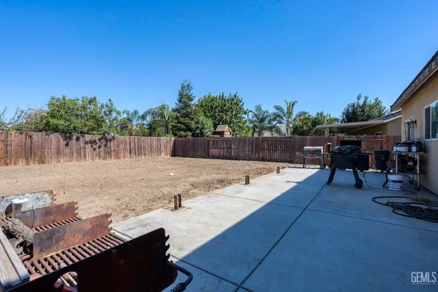 a view of a backyard with sitting area