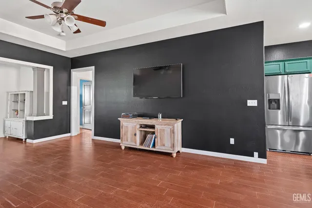 a view of a kitchen with a sink and a refrigerator
