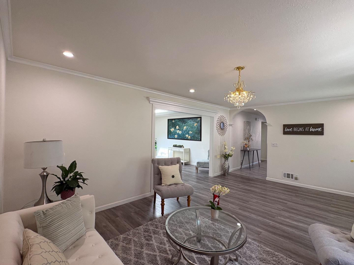 5187 Doyle Road San Jose, CA 95129 - Photo 11 of 39 a living room with furniture a dining table and a fireplace