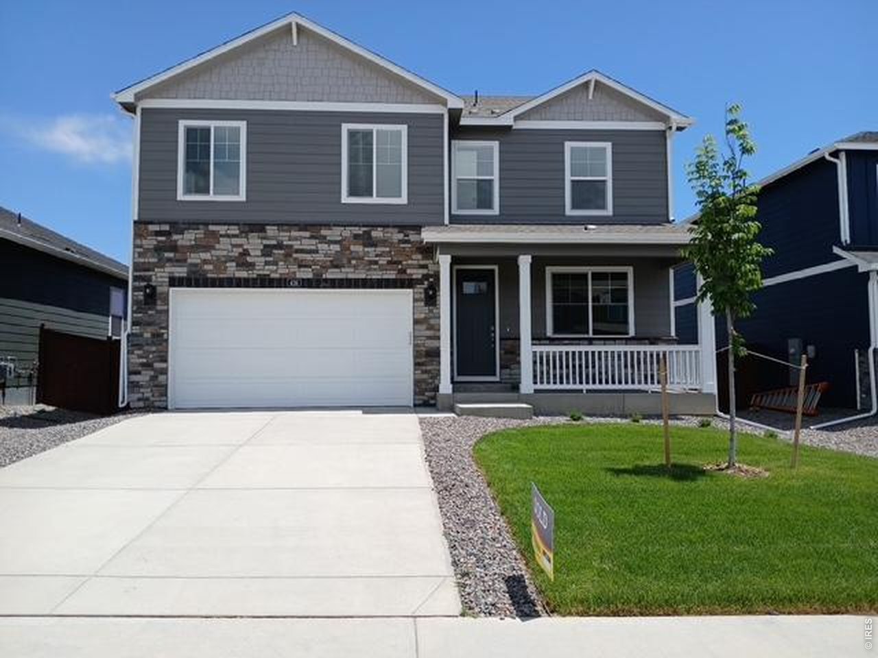 439 Bluebird Road Johnstown, CO 80534 - Photo 1 of 36 a front view of a house with a yard and garage