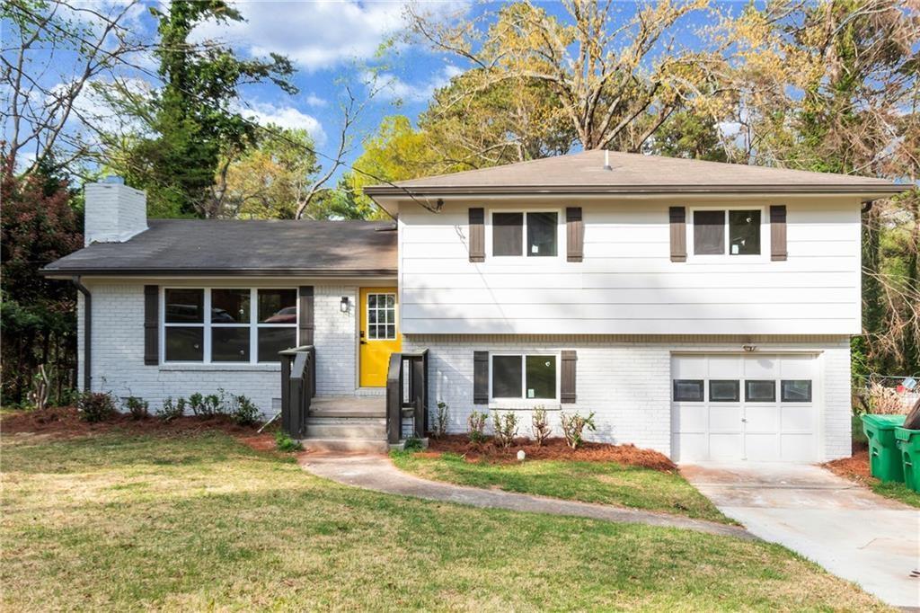 a front view of a house with a yard and porch