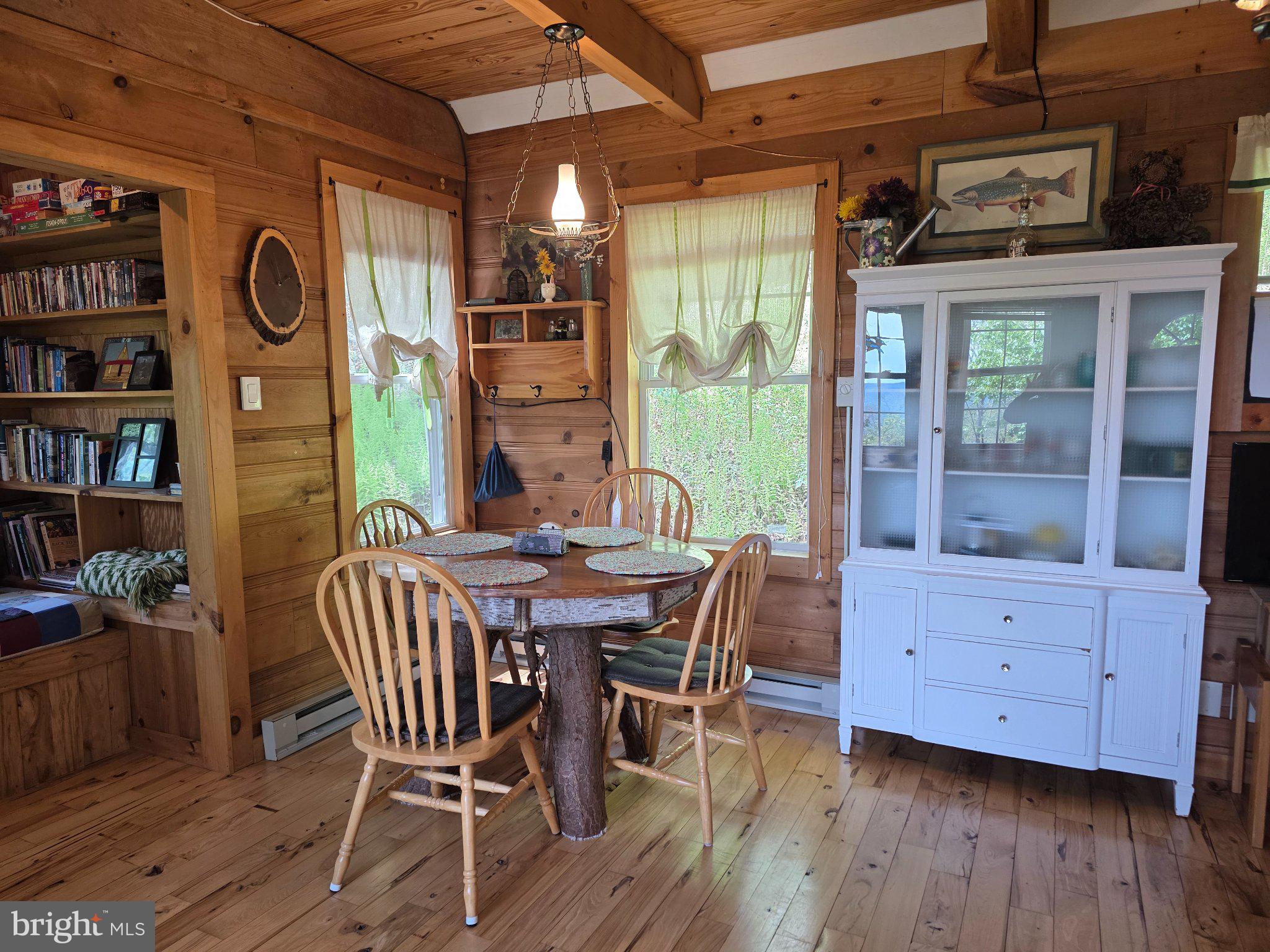 152 Sharp Ridge Lane Franklin, WV 26807 - Photo 10 of 53 a view of a dining room with furniture window and wooden floor