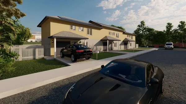 a view of backyard of house with green space