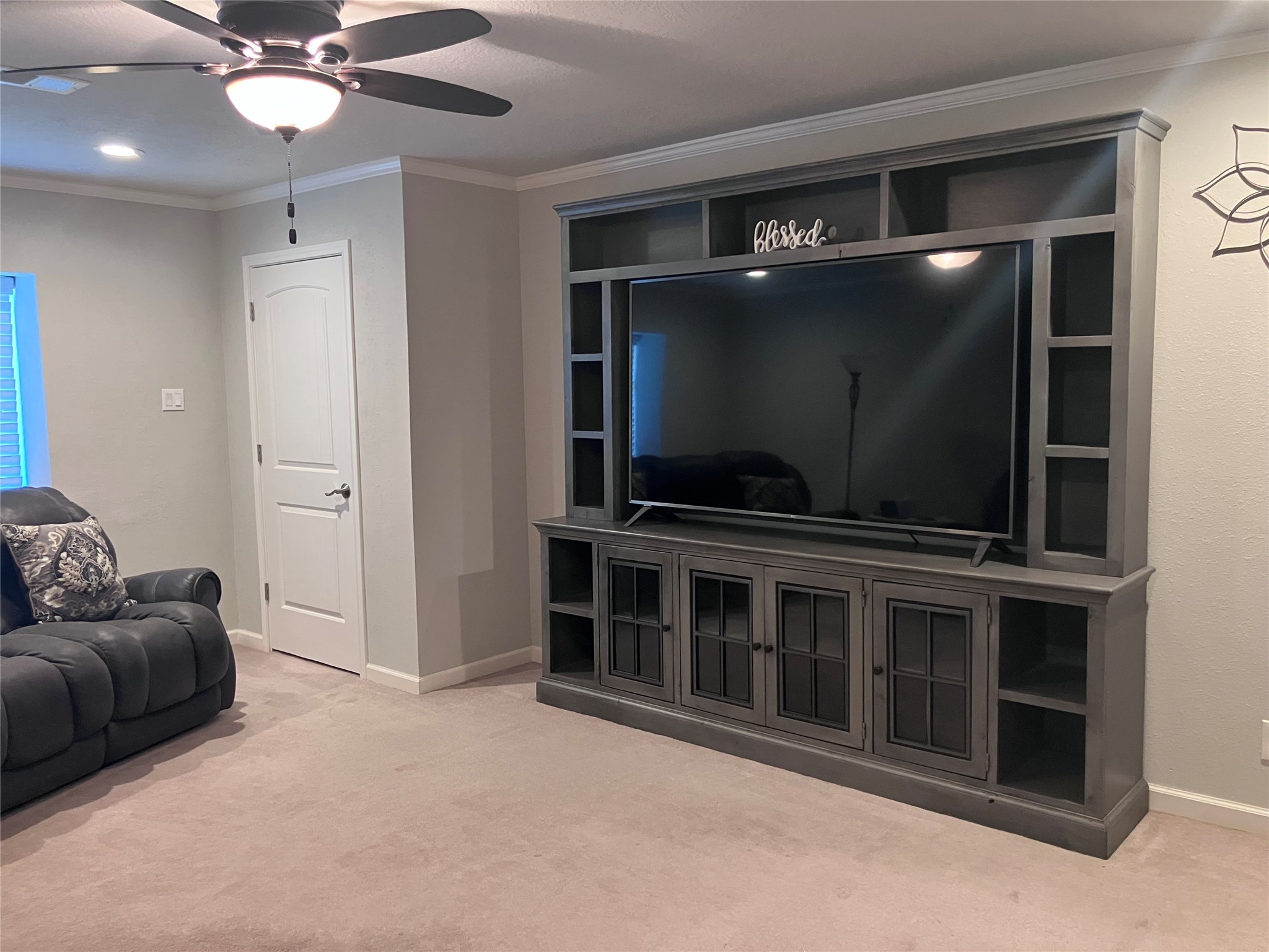 3807 Wade Street Santa Fe, TX 77517 - Photo 6 of 23 a living room with a flat screen tv and a ceiling fan