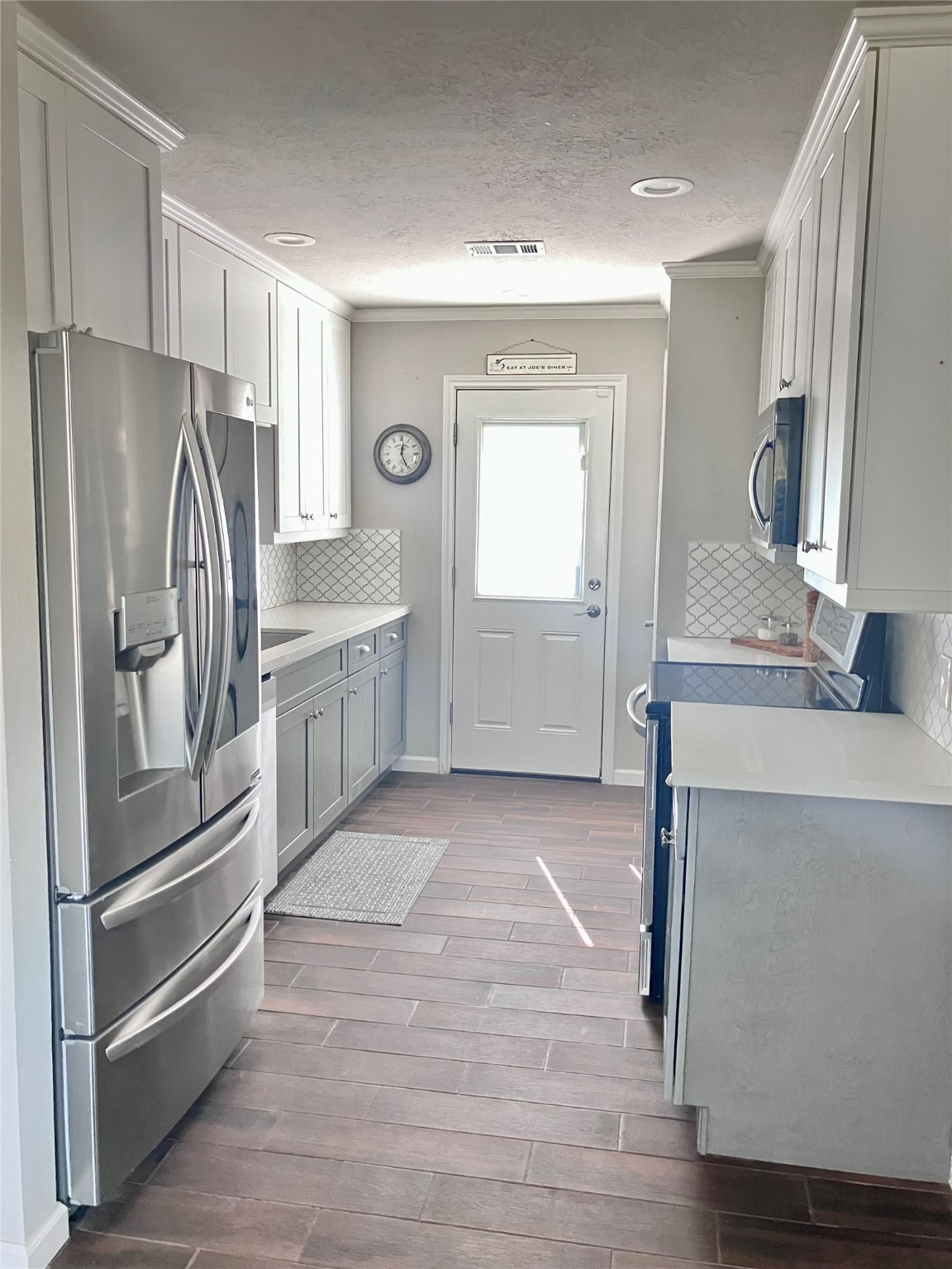 3807 Wade Street Santa Fe, TX 77517 - Photo 8 of 23 a kitchen with granite countertop a refrigerator and a sink