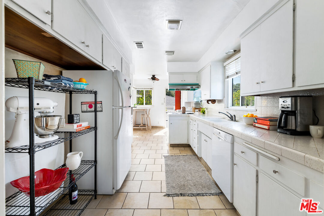 1856 Alpha Road Glendale, CA 91208 - Photo 11 of 32 a kitchen with stainless steel appliances granite countertop a sink and cabinets