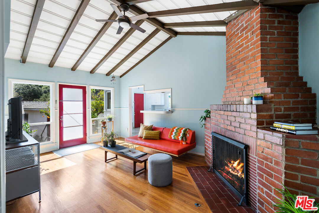 1856 Alpha Road Glendale, CA 91208 - Photo 20 of 32 a living room with furniture a fireplace and a table