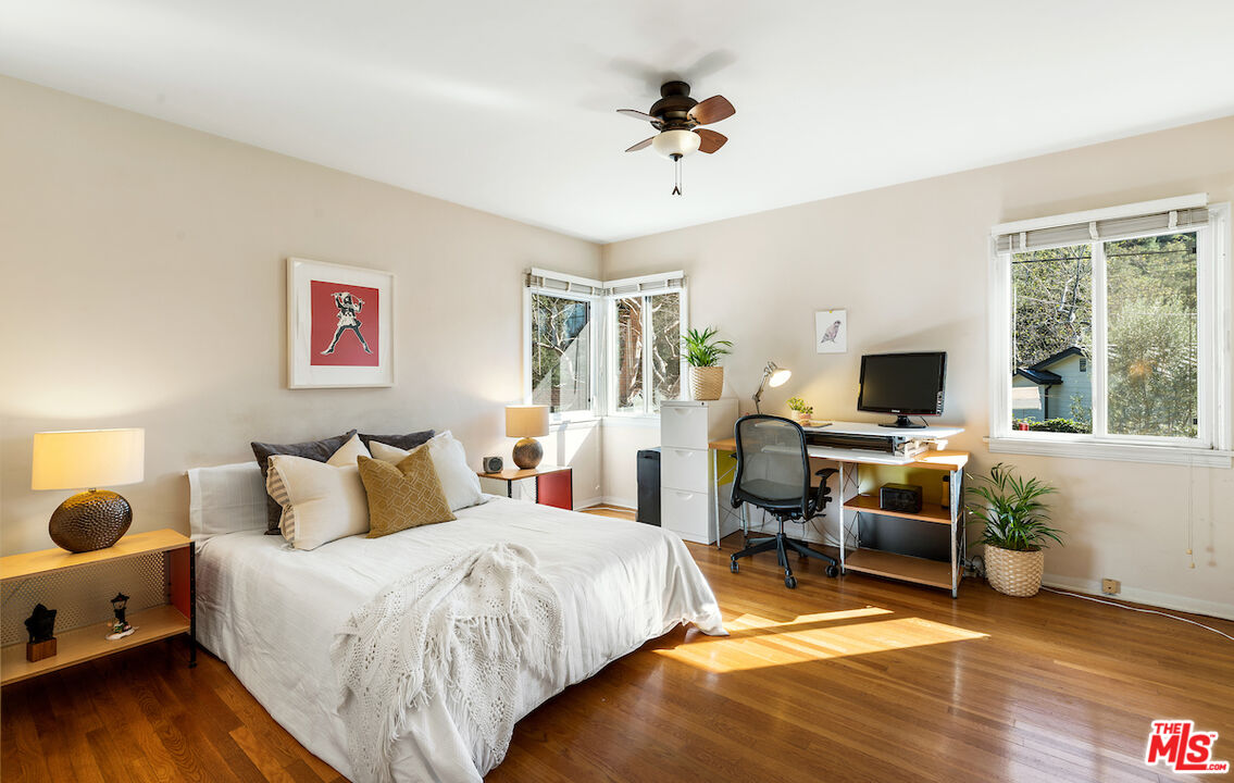 1856 Alpha Road Glendale, CA 91208 - Photo 21 of 32 a bedroom with a bed and wooden floor