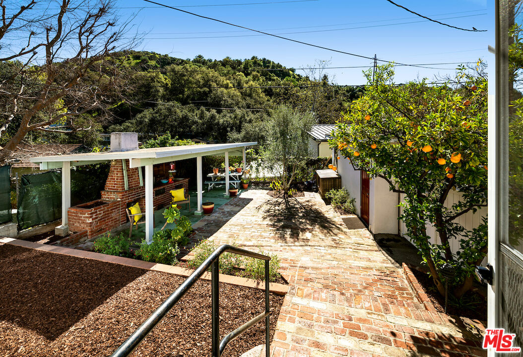 1856 Alpha Road Glendale, CA 91208 - Photo 27 of 32 a view of a patio with table and chairs potted plants and large tree