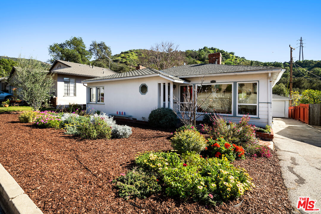 1856 Alpha Road Glendale, CA 91208 - Photo 3 of 32 a front view of a house with a yard