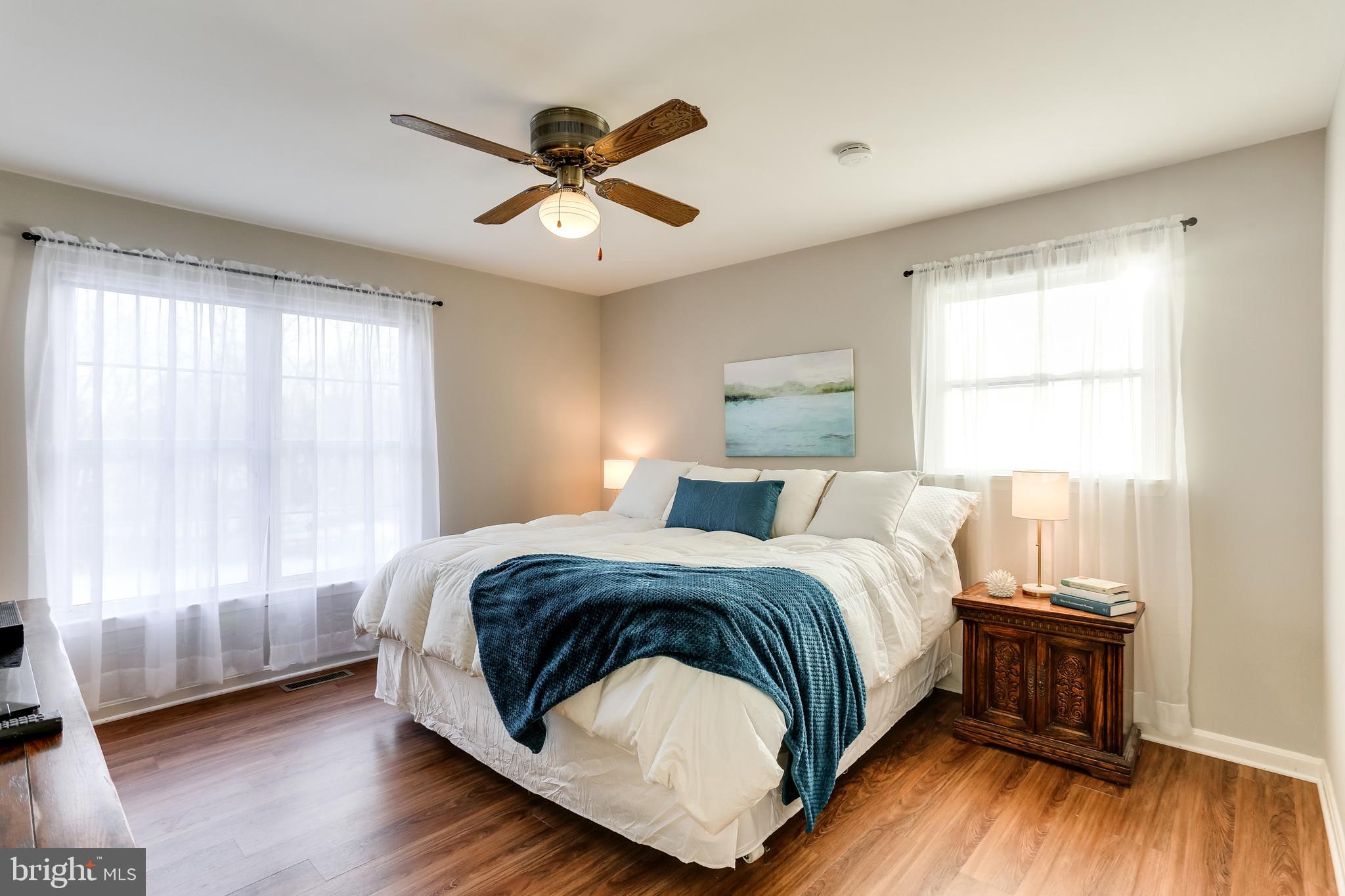 4939 A Elmer Derr Road Frederick, MD 21703 - Photo 11 of 29 a bedroom with a bed and wooden floor