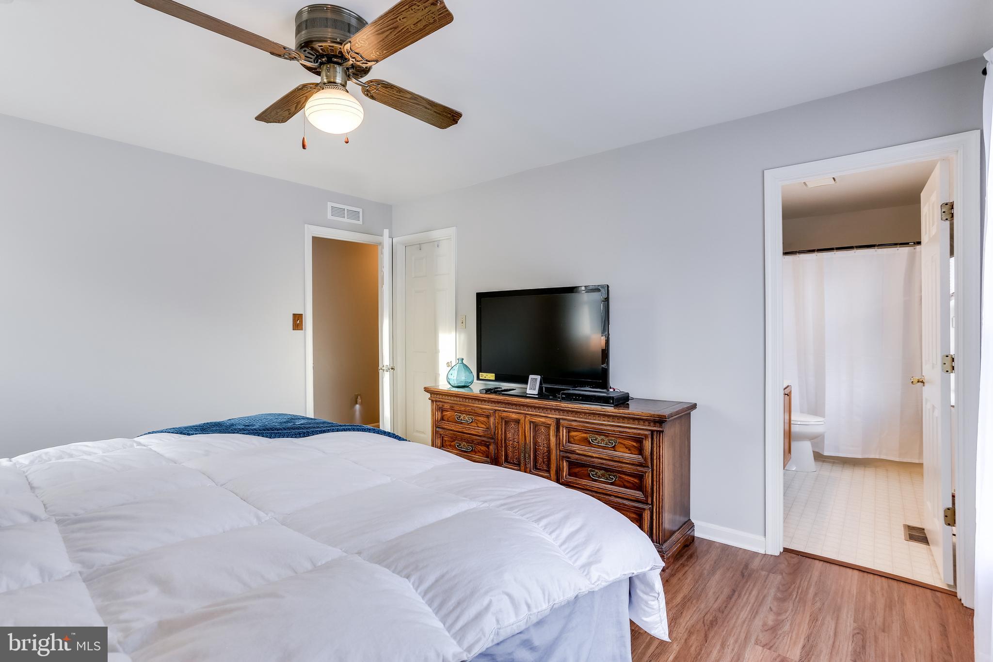 4939 A Elmer Derr Road Frederick, MD 21703 - Photo 12 of 29 a bedroom with a bed and a flat screen tv