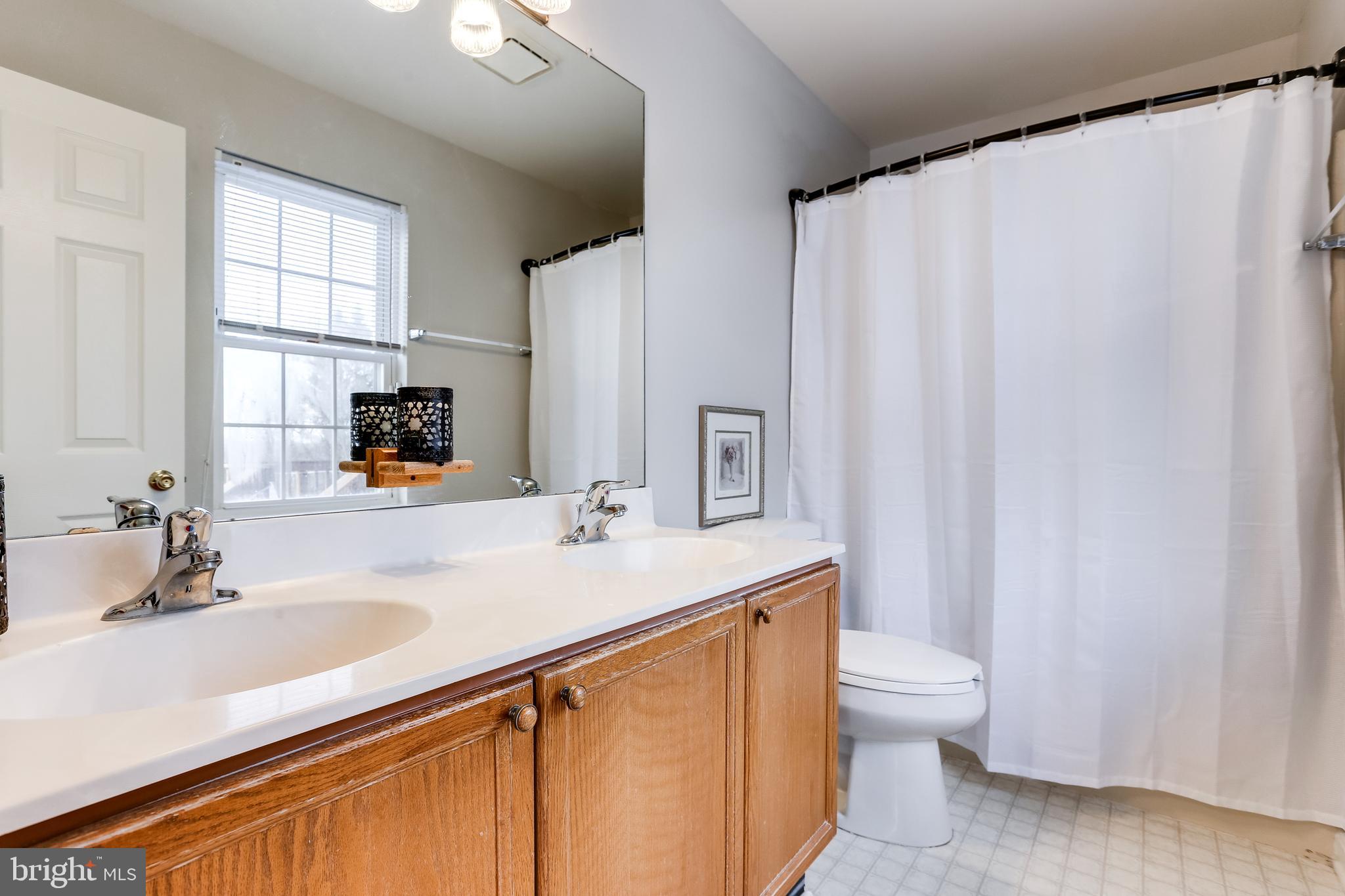 4939 A Elmer Derr Road Frederick, MD 21703 - Photo 13 of 29 a bathroom with a sink toilet and mirror