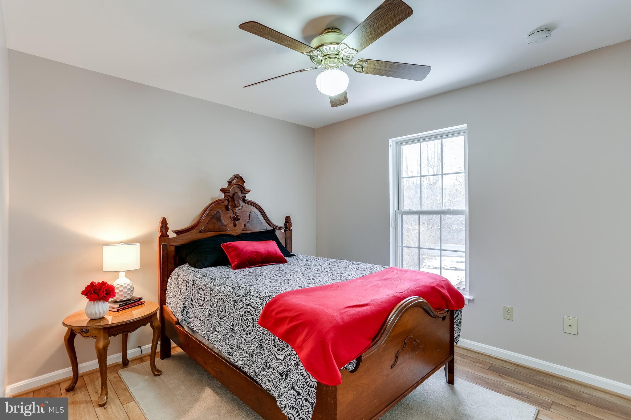 4939 A Elmer Derr Road Frederick, MD 21703 - Photo 14 of 29 a bedroom with a bed and a chandelier