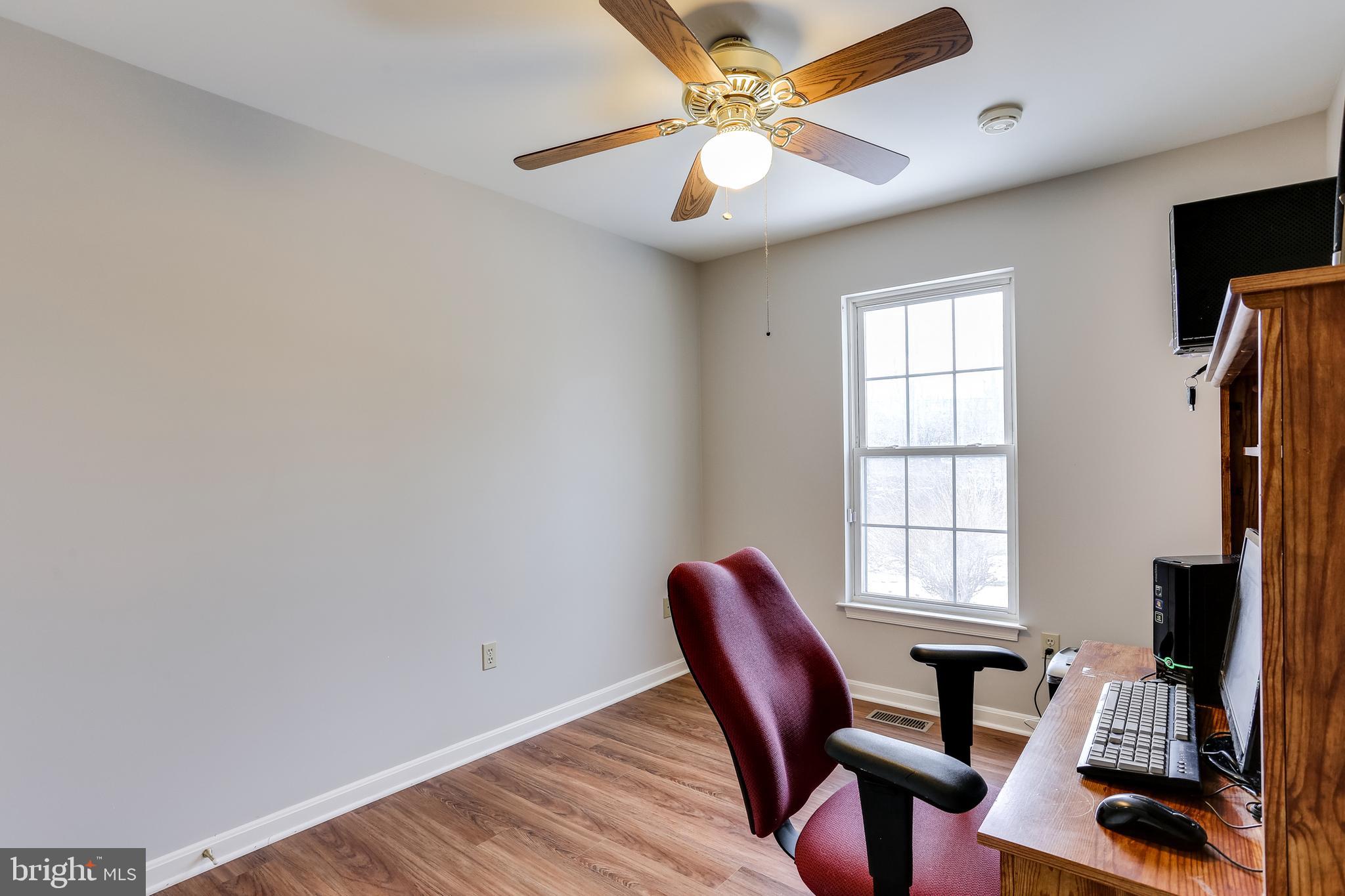 4939 A Elmer Derr Road Frederick, MD 21703 - Photo 15 of 29 a view of a workspace with furniture and a window