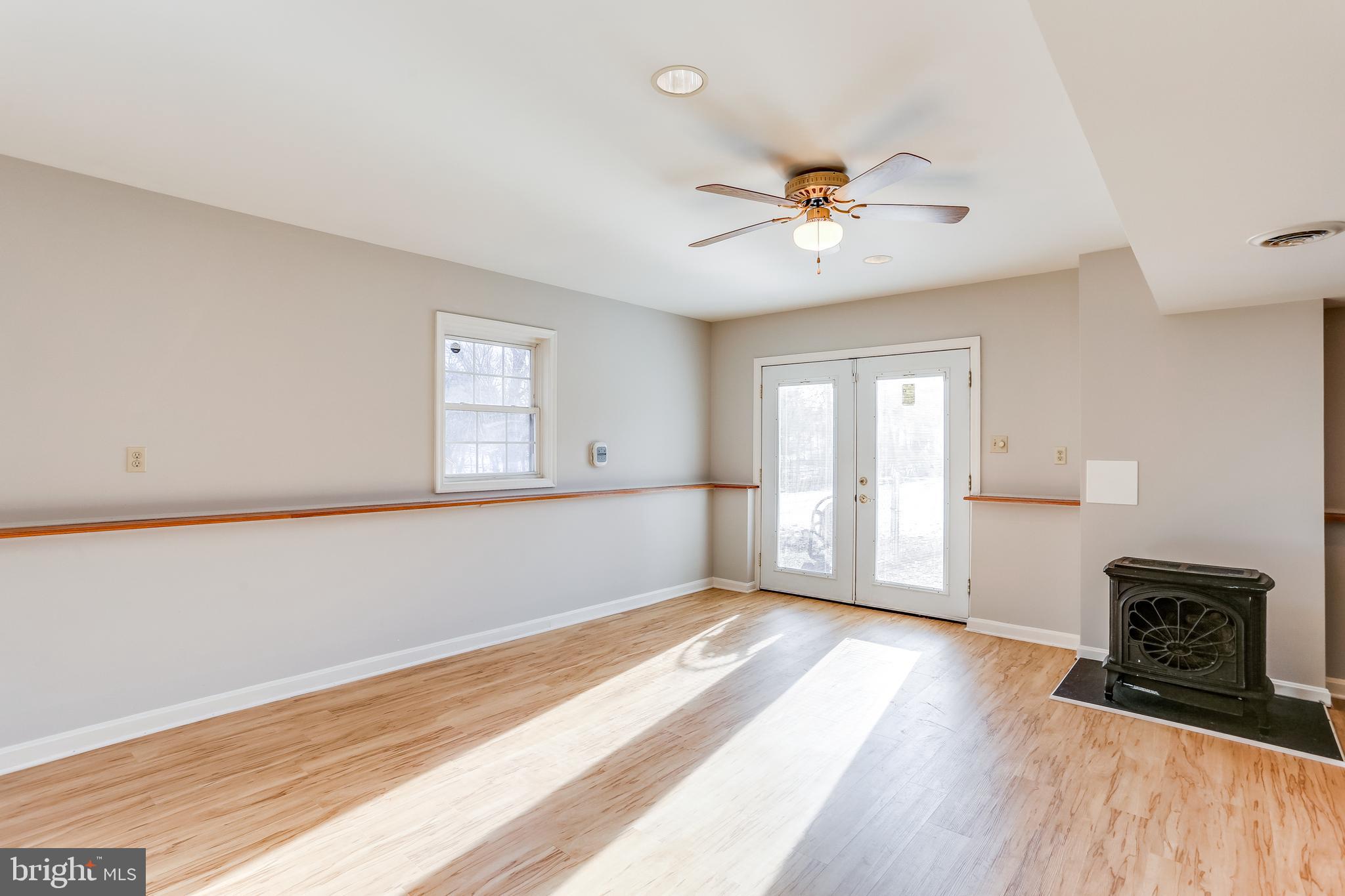 4939 A Elmer Derr Road Frederick, MD 21703 - Photo 21 of 29 a view of an empty room with window and wooden floor