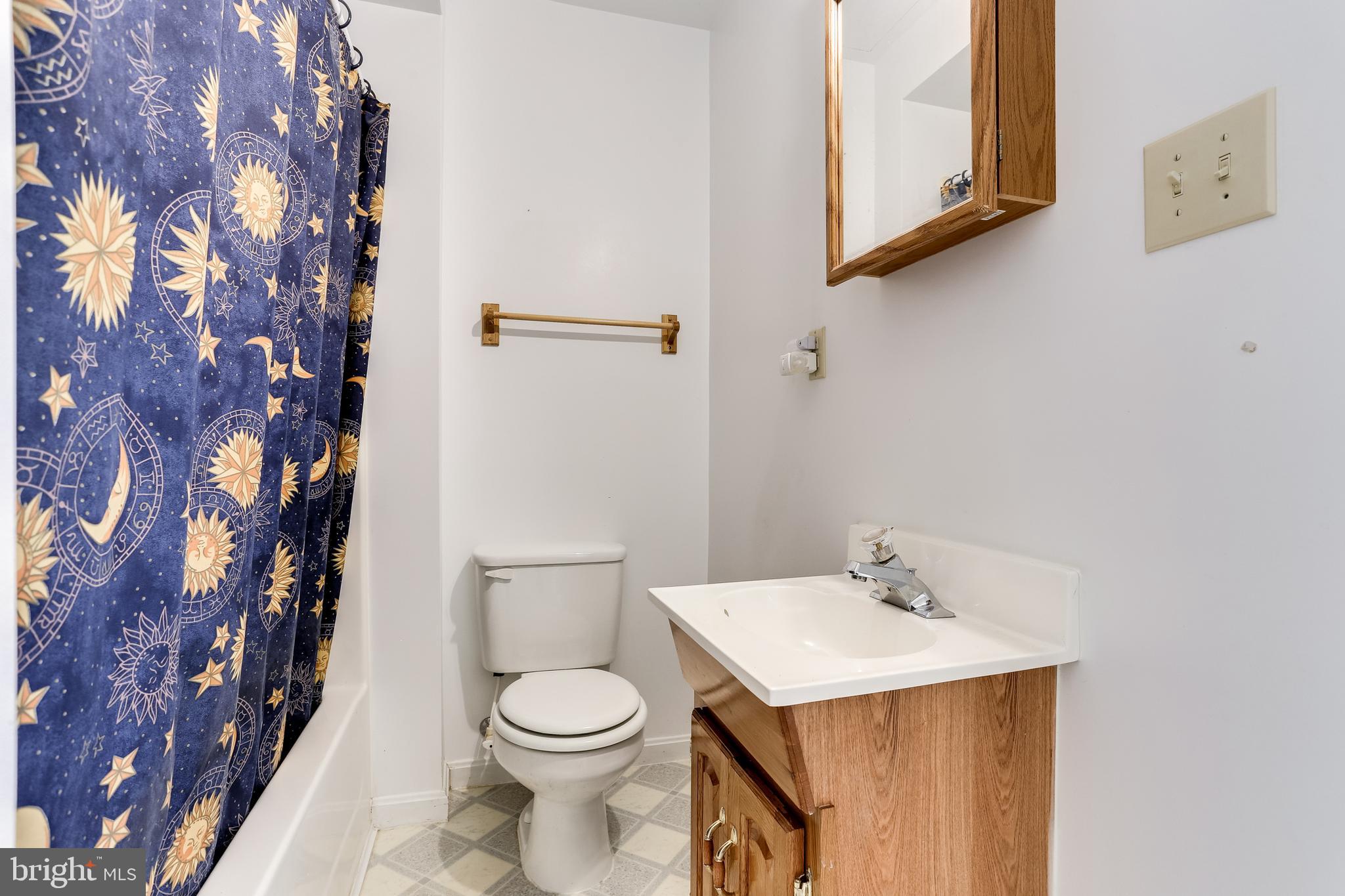 4939 A Elmer Derr Road Frederick, MD 21703 - Photo 22 of 29 a white toilet sitting next to a bathroom sink