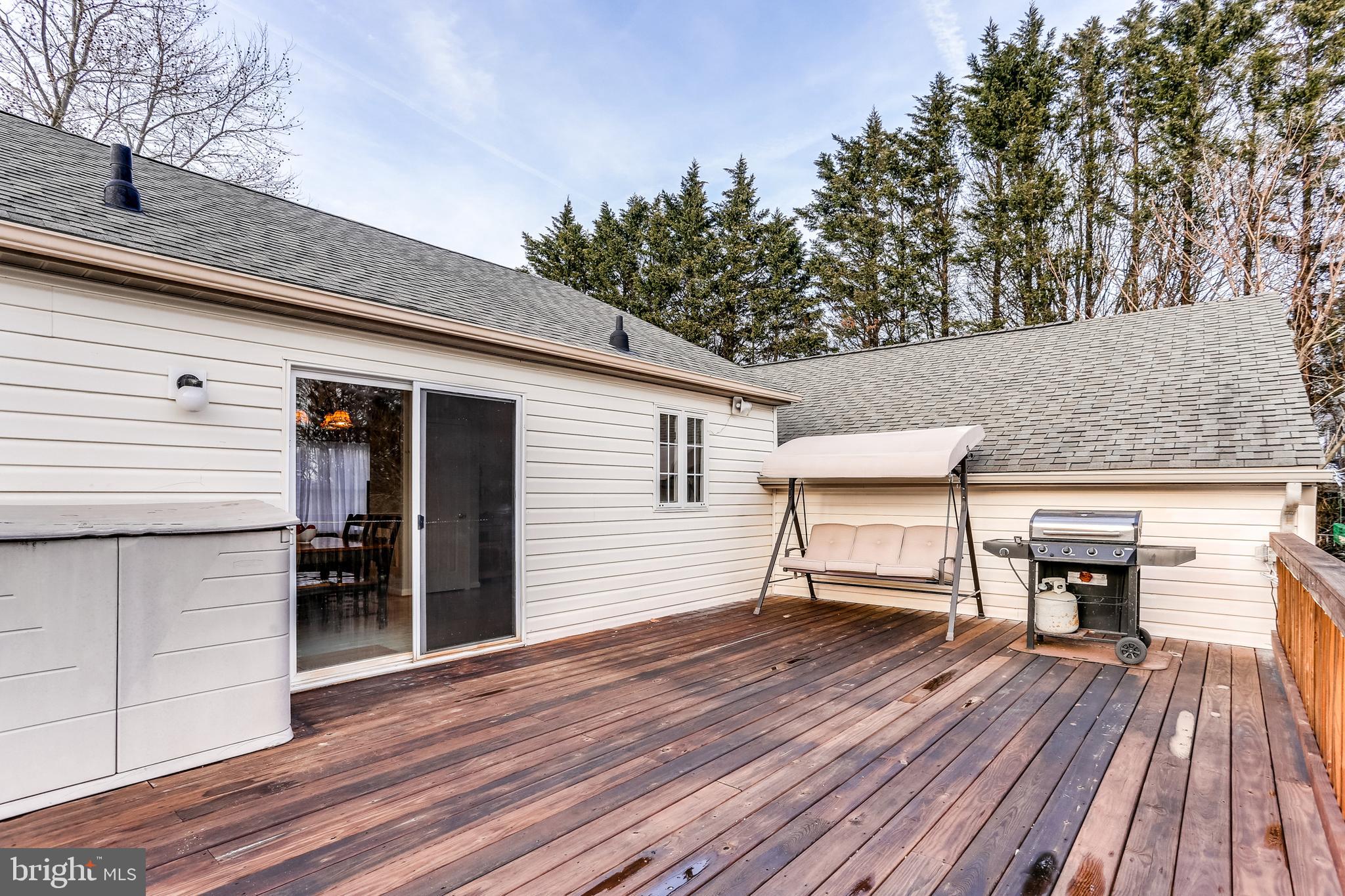 4939 A Elmer Derr Road Frederick, MD 21703 - Photo 24 of 29 a roof deck with table and chairs a barbeque with wooden floor and fence
