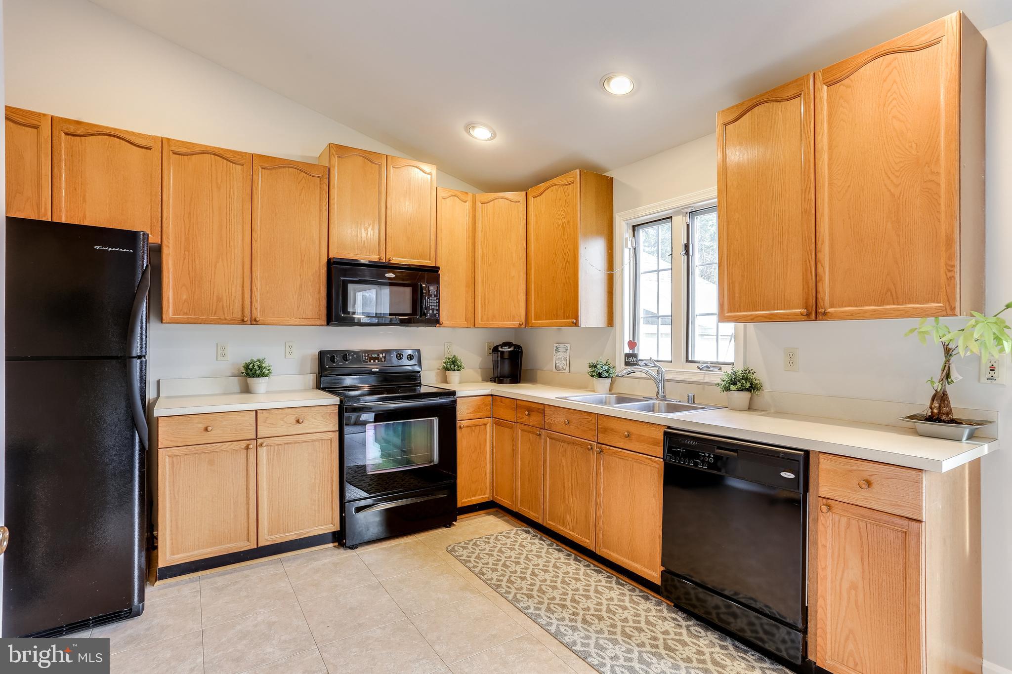 4939 A Elmer Derr Road Frederick, MD 21703 - Photo 4 of 29 a kitchen with stainless steel appliances granite countertop a stove a sink dishwasher a refrigerator and a microwave oven