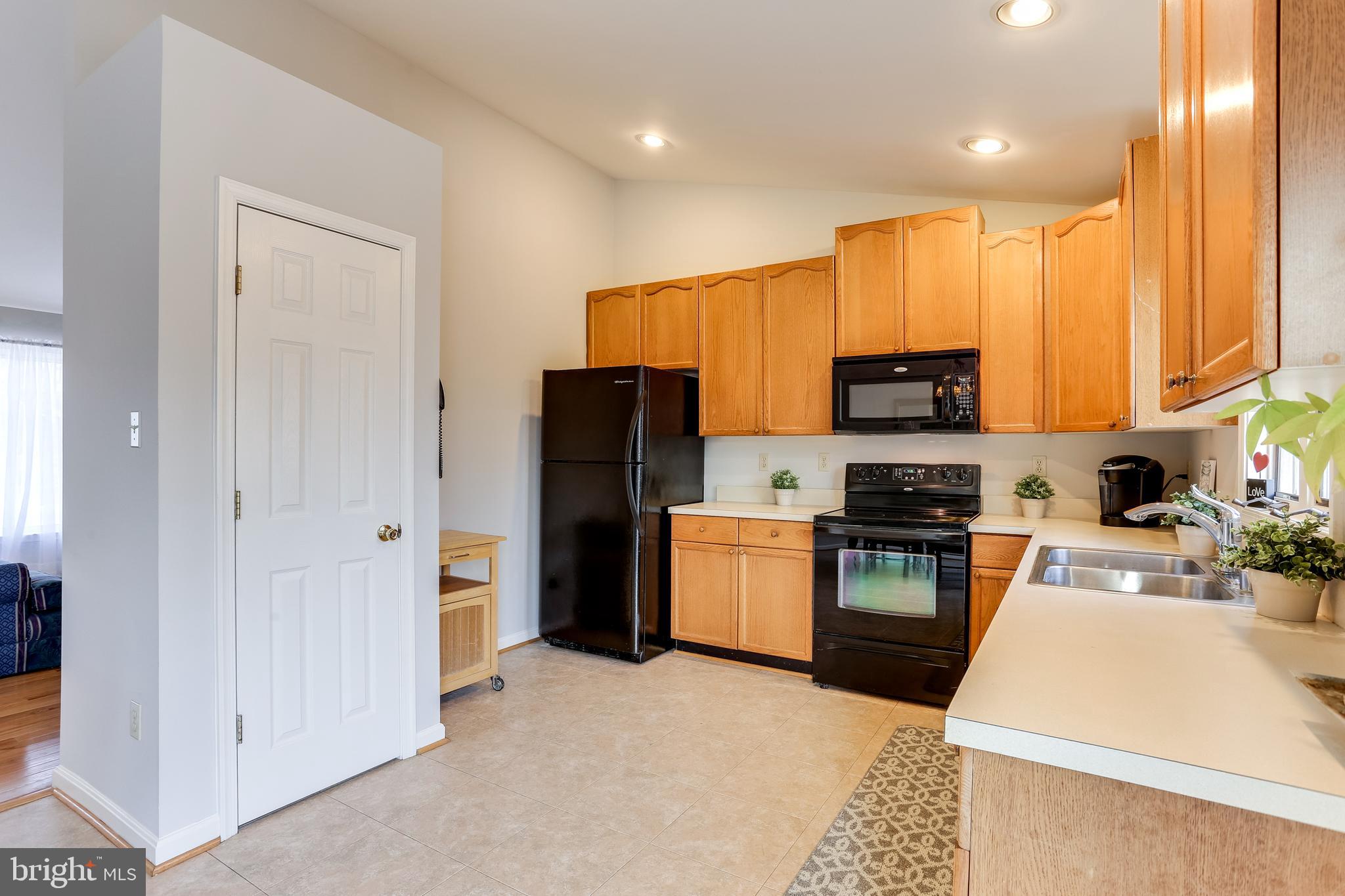 4939 A Elmer Derr Road Frederick, MD 21703 - Photo 5 of 29 a kitchen with stainless steel appliances a refrigerator sink stove microwave and cabinets