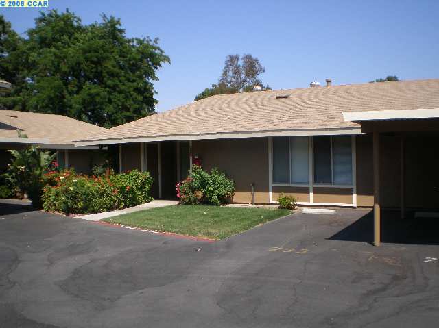 2035 Olivera Road, Unit A Concord, CA 94520 - Photo 1 of 1 a front view of a house with a garden and porch