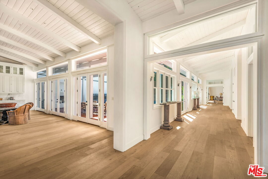9669 Oak Pass Road Beverly Hills, CA 90210 - Photo 19 of 37 a view of a room with wooden floor and furniture