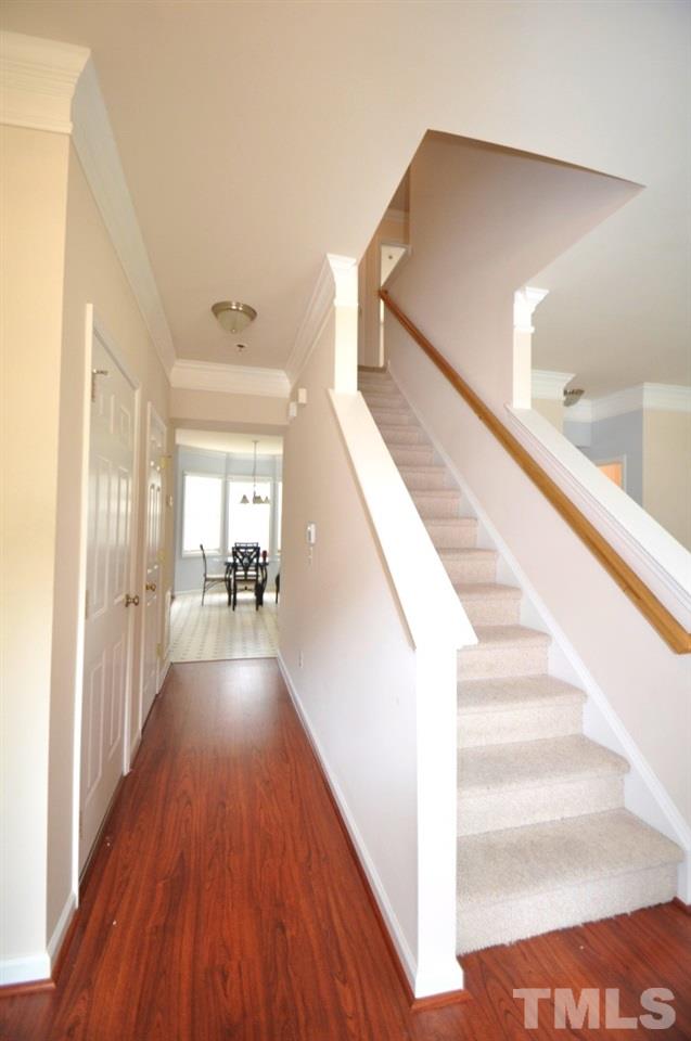 2529 Dality Drive Raleigh, NC 27604 - Photo 2 of 20 a view of a hallway with wooden floor and staircase