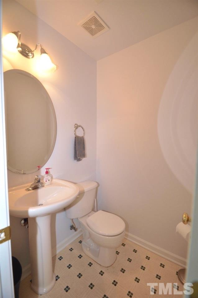 2529 Dality Drive Raleigh, NC 27604 - Photo 12 of 20 a bathroom with a sink a toilet and mirror