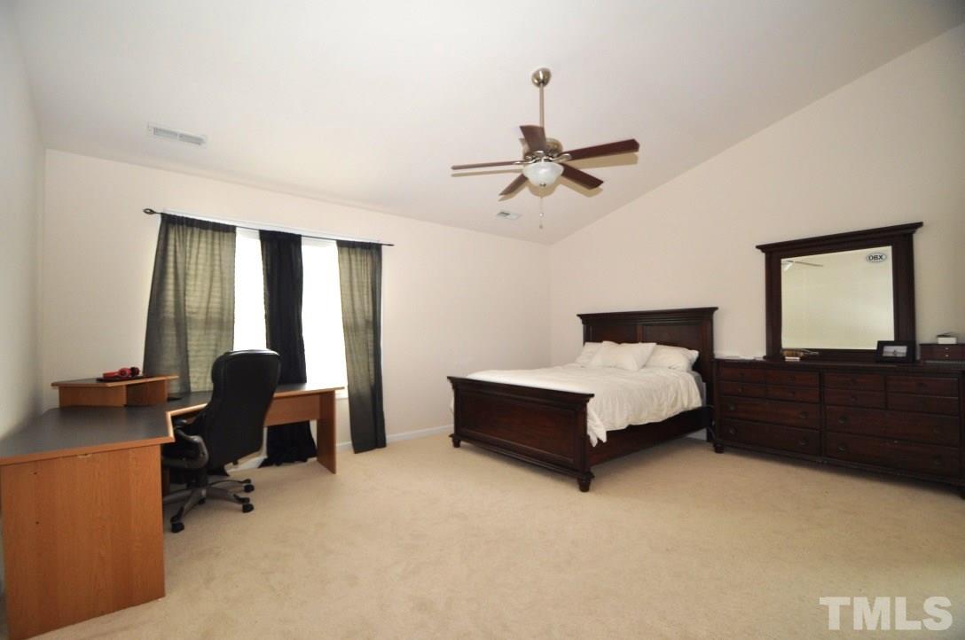 2529 Dality Drive Raleigh, NC 27604 - Photo 13 of 20 a bedroom with a bed a desk and chair