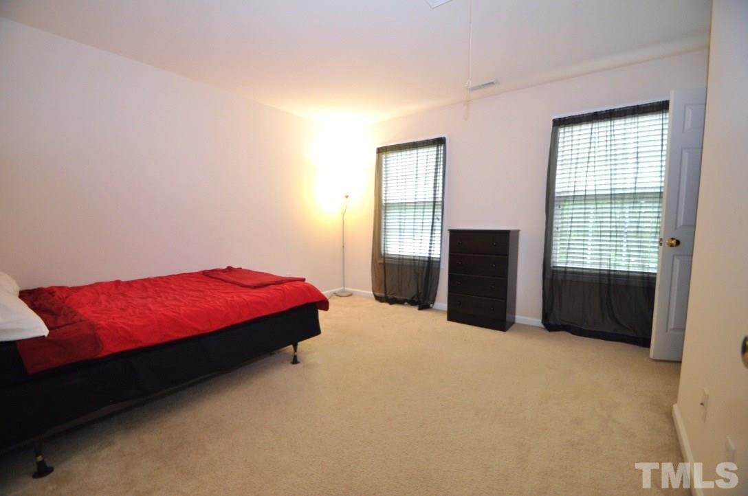 2529 Dality Drive Raleigh, NC 27604 - Photo 16 of 20 a bedroom with a bed and a window