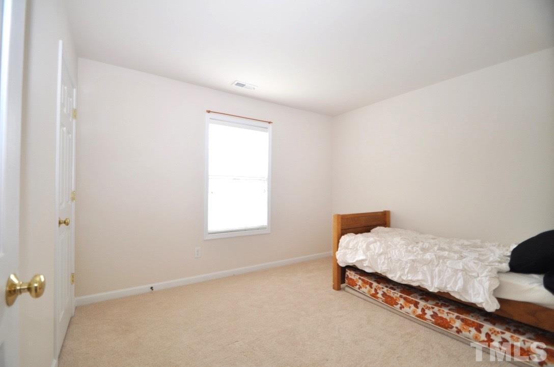 2529 Dality Drive Raleigh, NC 27604 - Photo 17 of 20 a bedroom with a bed and a window
