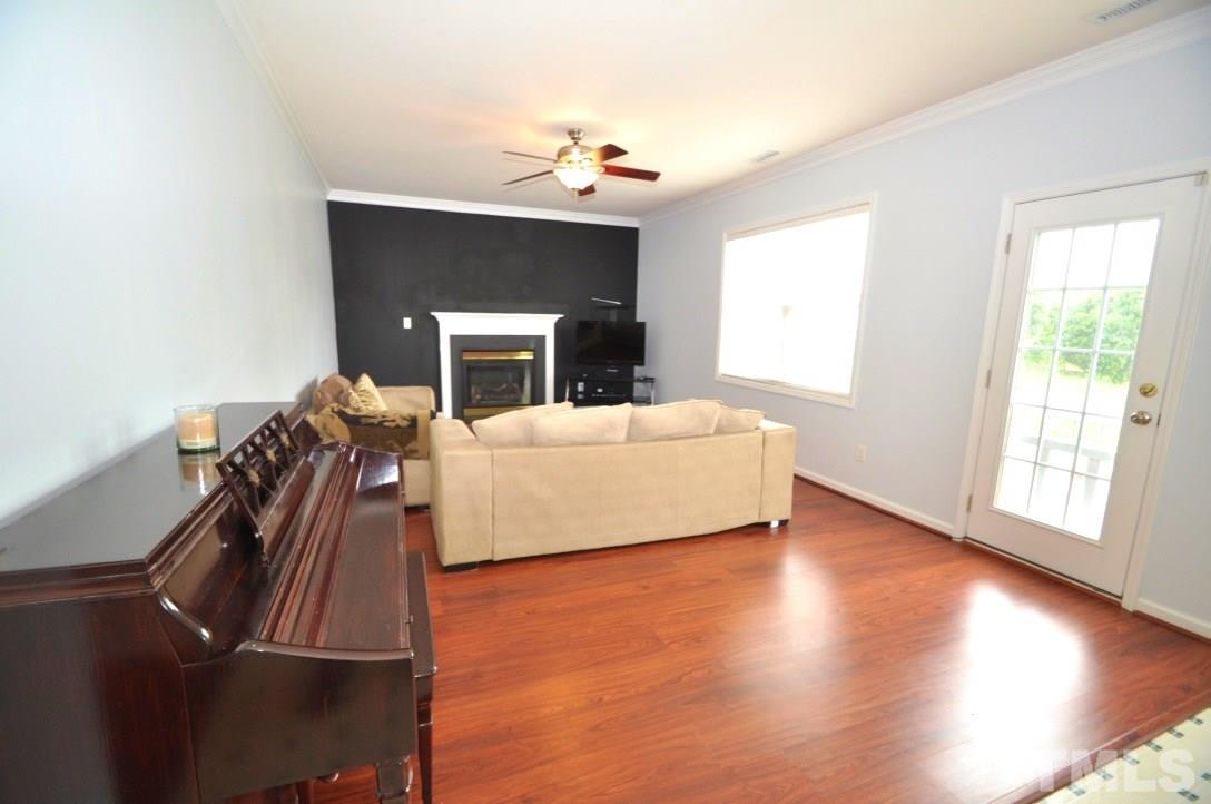 2529 Dality Drive Raleigh, NC 27604 - Photo 4 of 20 a living room with furniture fireplace and flat screen tv