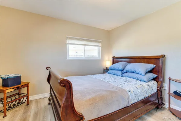 a bedroom with a bed chair and a window