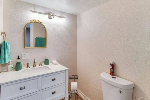 a bathroom with a sink mirror and vanity
