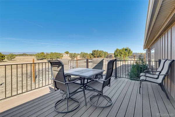 a view of a chairs on wooden deck