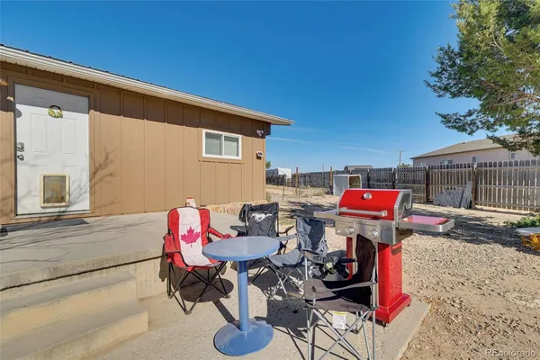 a view of a chairs and table in the patio