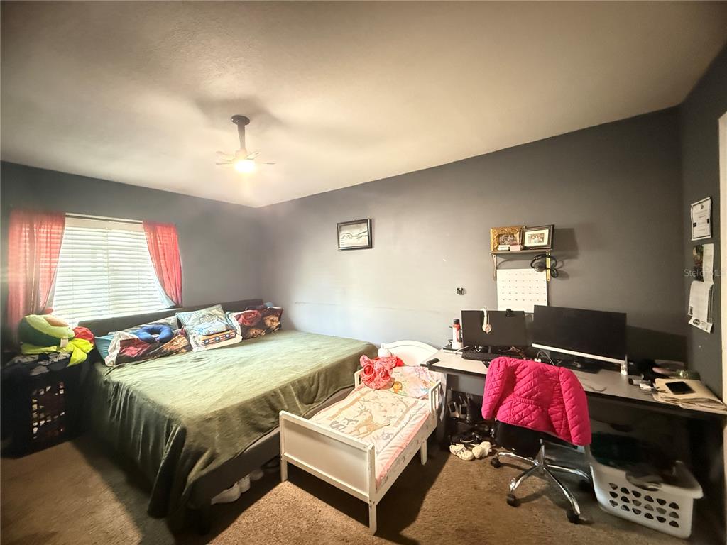 1944 South Conway Road, Unit 3 Orlando, FL 32812 - Photo 9 of 20 a bedroom with a bed and a chandelier