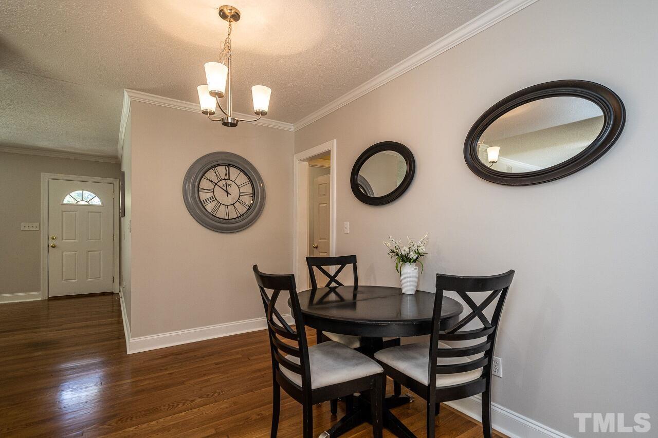 202 Purvis Street Garner, NC 27529 - Photo 12 of 29 a view of a dining room with furniture and a chandelier