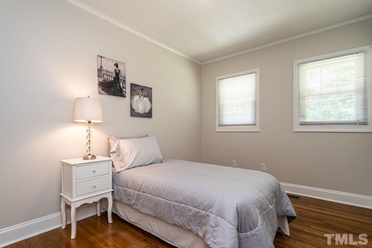 202 Purvis Street Garner, NC 27529 - Photo 16 of 29 a bedroom with a bed and wooden floor