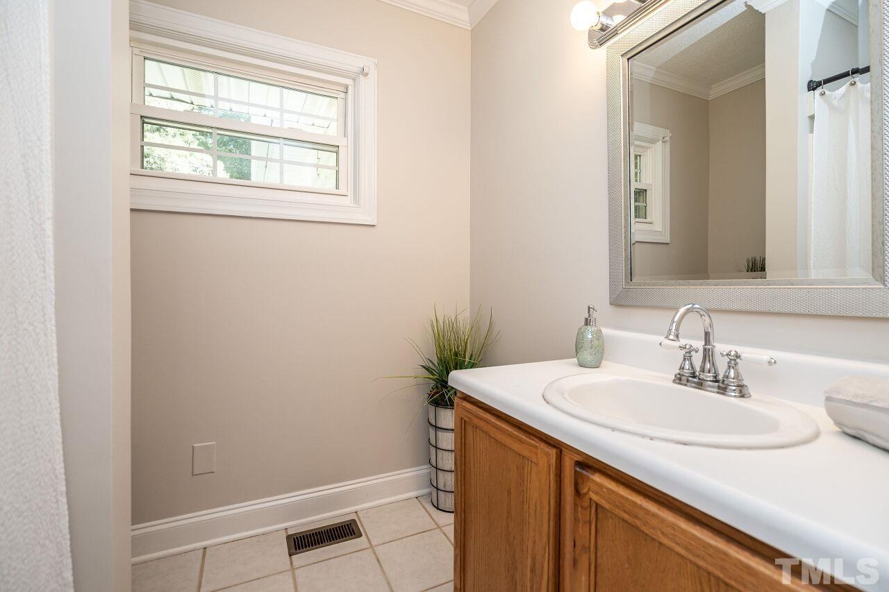 202 Purvis Street Garner, NC 27529 - Photo 17 of 29 a bathroom with a sink and a mirror