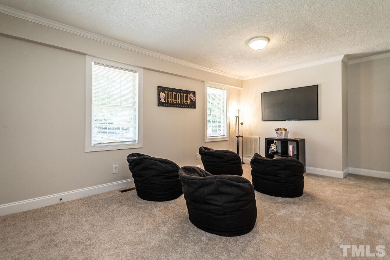 202 Purvis Street Garner, NC 27529 - Photo 20 of 29 a living room with furniture and a flat screen tv