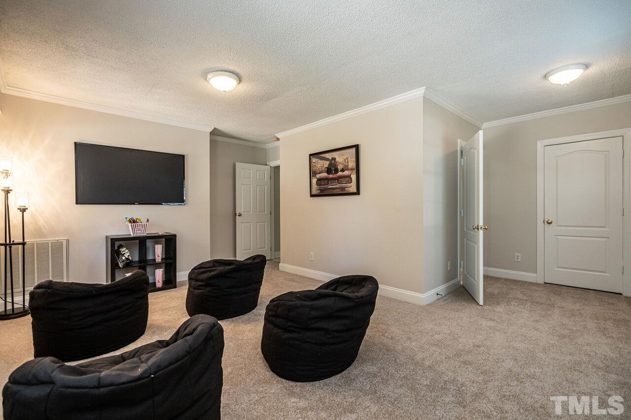 202 Purvis Street Garner, NC 27529 - Photo 21 of 29 a living room with furniture and a flat screen tv