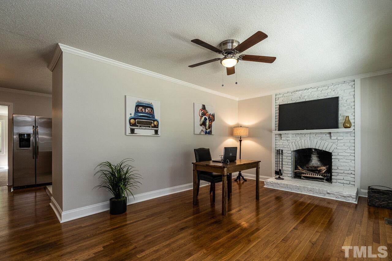 202 Purvis Street Garner, NC 27529 - Photo 4 of 29 a living room with furniture and a fireplace