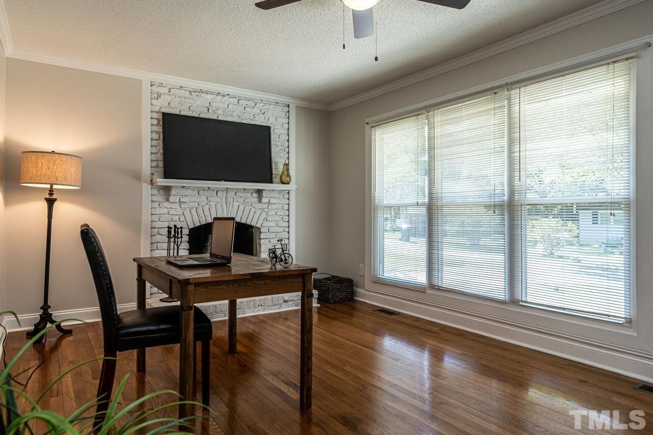 202 Purvis Street Garner, NC 27529 - Photo 6 of 29 a view of a livingroom with furniture a fireplace and wooden floor