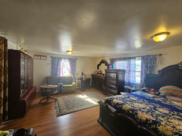 a bed room with furniture and a flat screen tv
