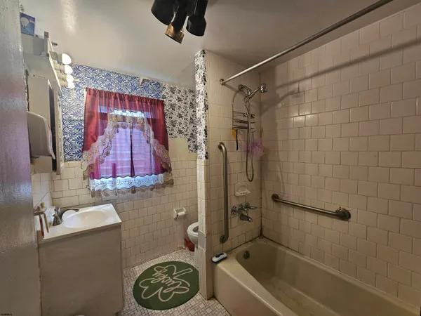 a bathroom with a shower a bath tub and a shower