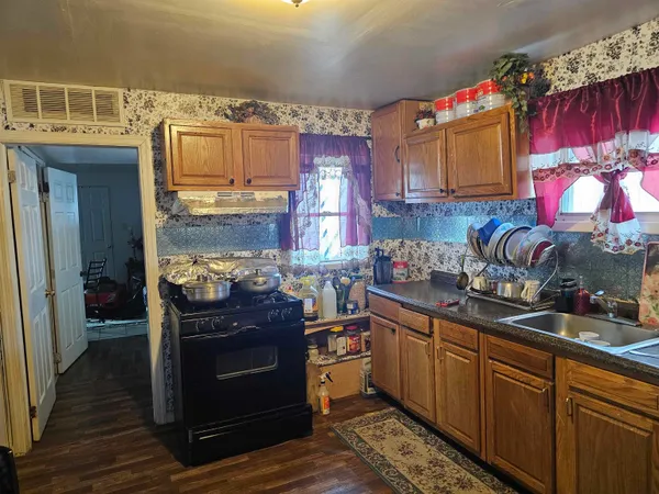 a kitchen with stainless steel appliances granite countertop a stove and cabinets